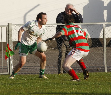 Lisnaskea's Paul Curran keeps Paul McCusker forced into the corner of the pitch   SHFH18