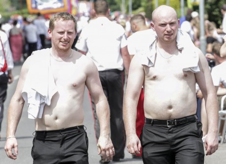 Brothers William and Andrew Curran of Stonepark go bare chested on the way back from the field as the sun blazes down