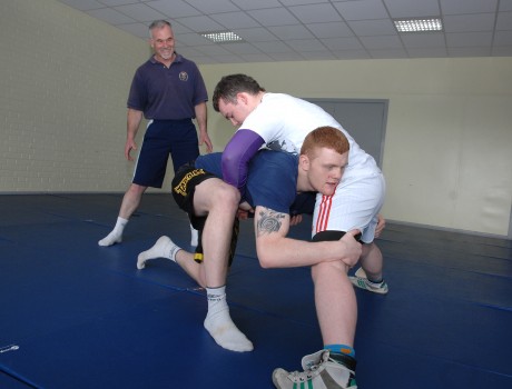 Two members of the Erne Wrestling club based at the Lakeland Forum, pictured  getting to grips with each other under the watchful eye of coach Bruce Irwin. The wrestlers are Glenn Irvine and Christy Sweeney gkfh2