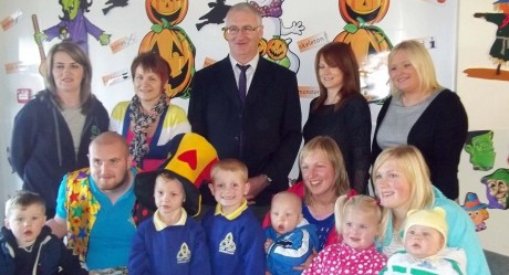 FUNDING BOOST...Devenish Partership's Laura Coalter (rear, left) with some of the Early Days staff, parents and children