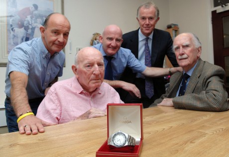Ted keenan, looks at the watch he wore when training and swimming the English, The North and the Bristol Channels. The watch was given in 1973 by Keith Styles, right of T.A. Mercer's Jewellers to help ted with his training. Ted's sons Brian and Tony took the watch back to the jewellers and with the help of Jonathan Styles, back right he had the  Omega watch restored to it's original condition. The group are pictured together in the County Nursing Home where Ted is now a resident 