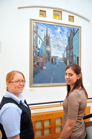 Joanne Watson and Brigid Jones members of the Fermanagh County Museum staff admiring the painting commissioned by  Canon Peter O'Reilly  of the Queen's visit last year which is on display in the museum 