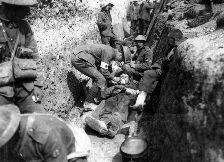Royal Inniskilling Fusiliers tending wounded Beaumont Hamel in the mud.