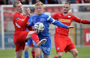 Cliftonville's Chris Curran in action with Ballinamallard's John Curry