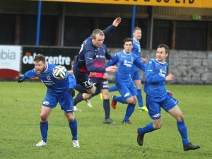 Midfielder Raymond Foy challenges for a loose ball surrounded by Dungannon players.