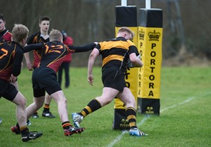 Jack Moore makes it past the uprights to score Portora's third try.