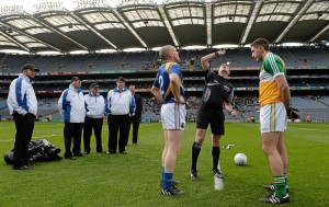 Referee Niall Cullen tosses the coin before the Allianz Football League Division 4 final between Longford and Offaly as Longford captain Dermot Brady and Offaly captain Paul McConway look on.