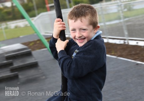 Matthew James can't help smiling as he has a go on the zip line at the newly opened play park
