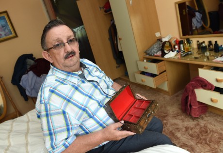 Anthony McGirr sits in his ransacked bedroom with the empty jewellery box that held his late wife's valuables, including her engagement ring, before they items were stolen when his house was burgled recently    RMGFH54