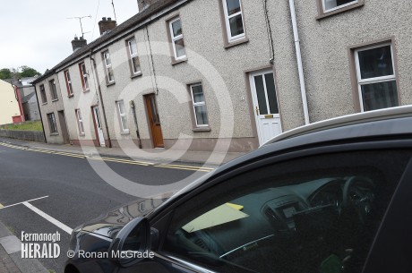 An unmarked police car keeps watch at St Patrick's Terrace, Lisnaskea, where the bodies of two men where discovered last night    Photo by Ronan McGrade