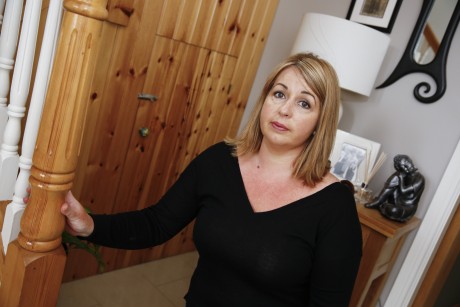 Aine McQuillan, who had a safe, a gun safe and two shot guns stolen from her home poses beside the understairs cupboard from which the safe was stolen    DP05