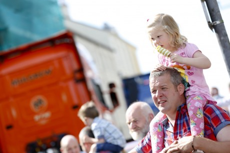 Andrew Forde gives little daughter, Katie a good view point for the lorries