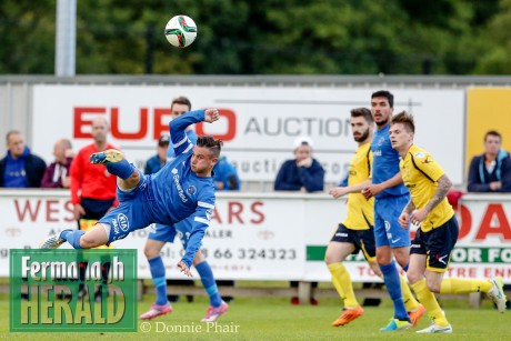 Shane McCabe takes to the air to thump a ball back towards the Dungannon goals.