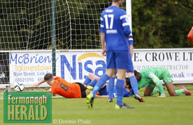 During the confusion, a goal slips in for Kyle Cherry of Carrick.