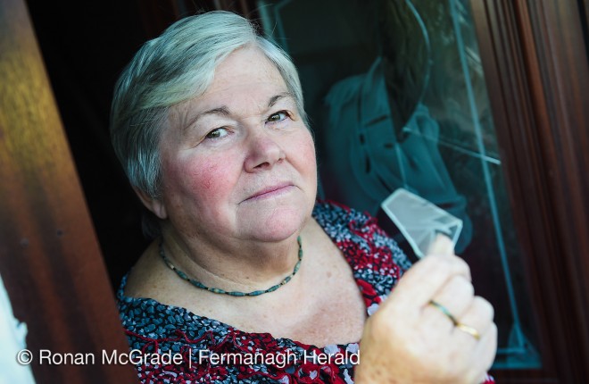 Florence Creighton shows some of the broken glass from her front door    RMGFH102
