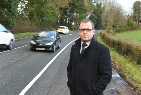 Councillor Raymond Farrell stands beside the Mossfield Road (main A32 road to Irvinestown) RMGFH342