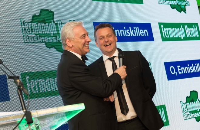 Terry McCartney of the Belmore Court & Motel, the 2015 Business Person of the Year, pictured on stage with MC for the evening, UTV's Paul Clark
