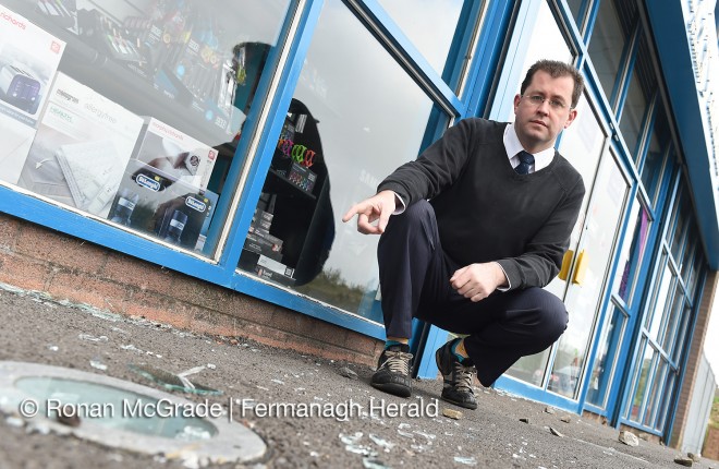 Ronan Reilly points to shattered glass at his premises along the Cornagrade Road, Enniskillen
