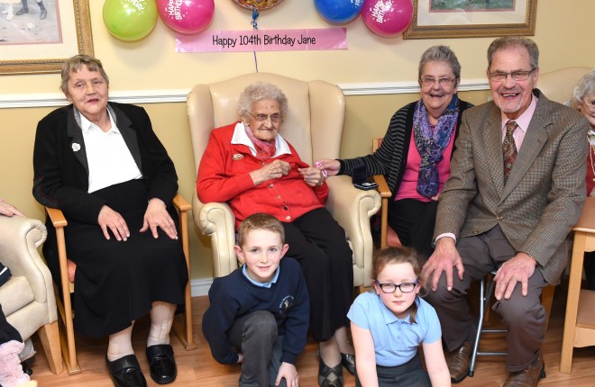 Helping Mary Jane Cathcart, centre, celebrate her 104th birthday earlier this year were, from left, Emily Carson (daughter), Annie Millar (daughter) and Tommy Cathcart (son).  Kneeling at the front are Mary Jane's grandchildren Dylan and Alice Seaney    RMG90