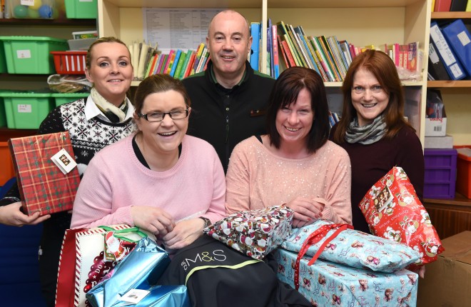 Staff from Marks and Spencer, Enniskillen took part in the 'Bring Magic and Sparkle Appeal' where they bought Christmas presents that will be delivered to local families in time for Christmas.  From left, Catherine Connolly (Marks and Spencer), Breda Kerrigan (Marks and Spencer), Victor Bradley (Marks and Spencer), Wendy Conlin (Westville Family Resource Centre) and Doreen Mullan (Westville Family Resource Centre)    RMG10