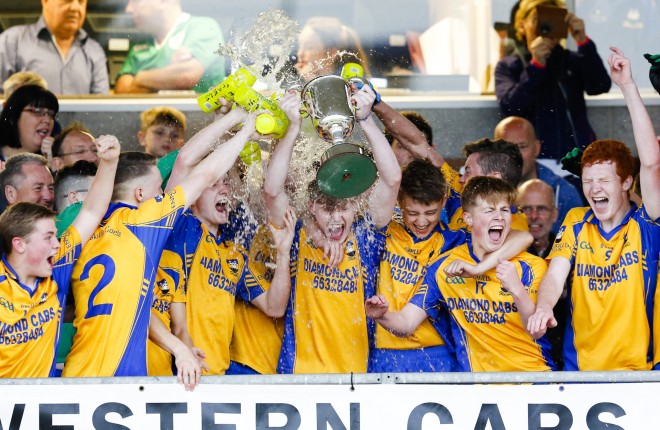Conor Carney lifts the cup and is soaked in glory