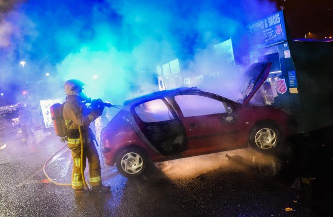 Firefighters extinguish the flames of a car that caught fire on Monday 14th December 2015 at Asda, Enniskillen    RMG12