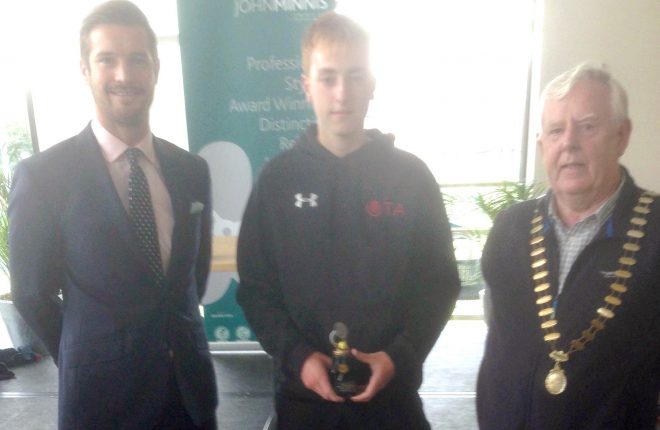 Kyran Maguire, centre, pictured after his under 16 singles victory at the Belfast Hardcourt Championships.