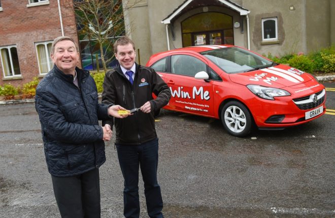 Fr Brian D’Arcy receives the keys to a brand new Vauxhall Corsa, which is up for grabs in the Graan Prize Draw, from Dessie Dolan, Dealer Principal at Lochide Garages, Enniskillen    