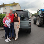 fascinated by the tractor's is young Ruby McGorman with Grandparents Rosemary and Patrick and Mum Michaela Murphy.