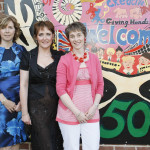 Helen Bullock-Mcfarlane, Bernie Cargill and Hether Kettyle beside the sign painted by the art students, to celebrate their 50th celebration SH16
