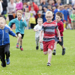 Children taking part in the fun run in front of a large crowd of mums and dads who were cheering them on bmcb 112